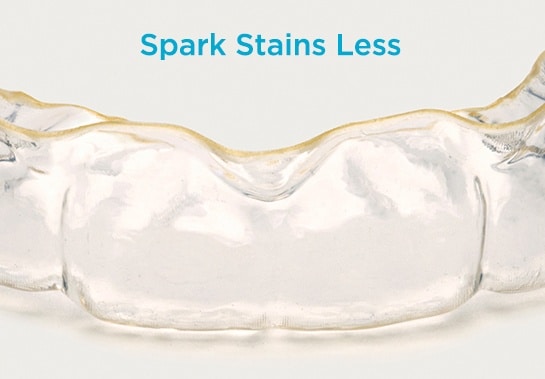 Competitor aligner showing yellow staining after wear